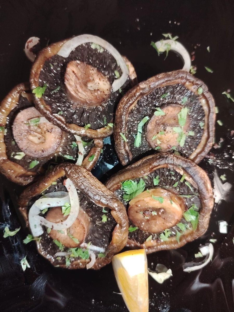 Charcoal-grilled portobello mushrooms dressed with onion, parsley and lemon